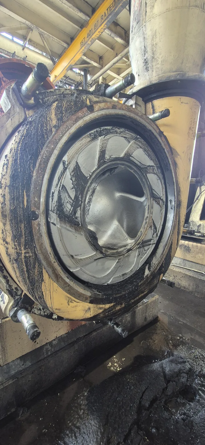 A slurry pump opened up for maintenance, showing its worn impeller